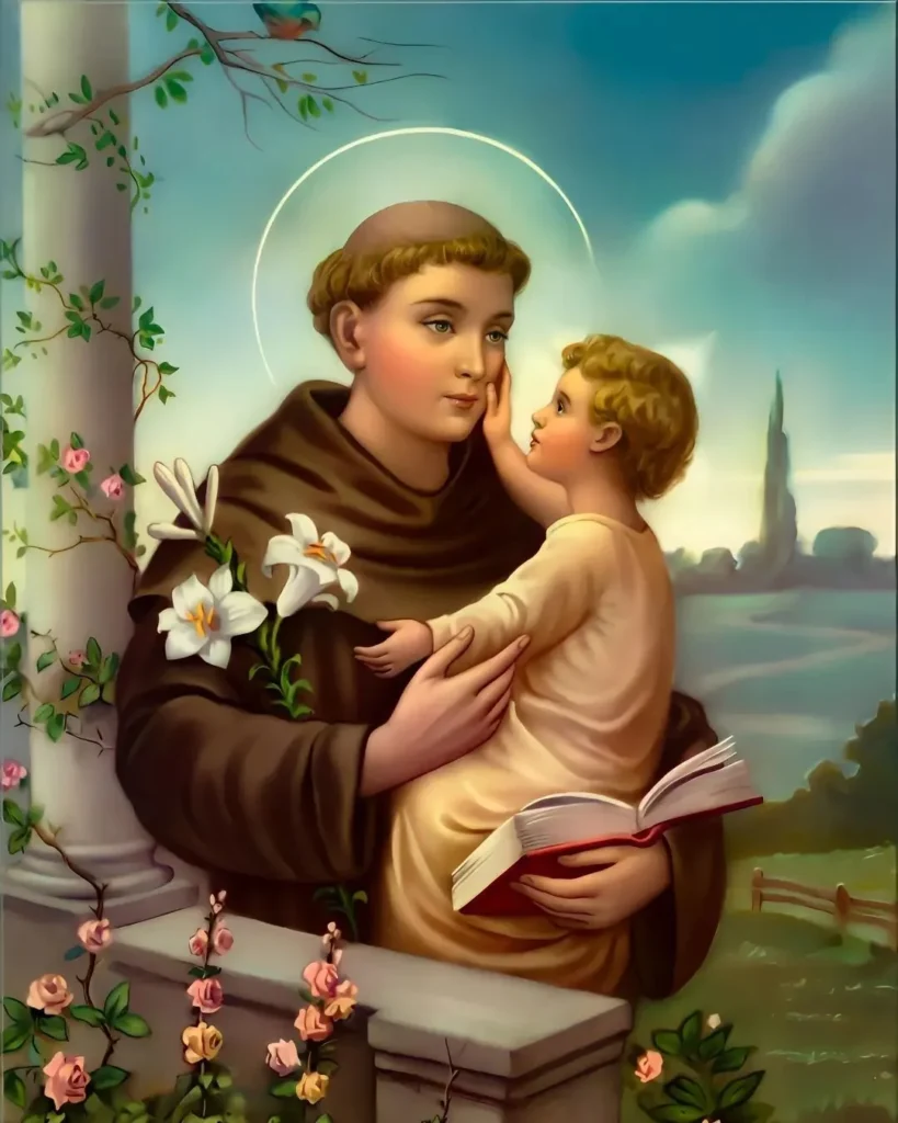 imagem, foto de santo antônio de pádua e o menino jesus sendo segurado no colo junto com livro